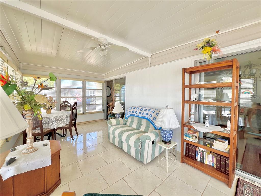 1100 South Belcher Road, Unit 719 Largo, FL 33771 - Photo 16 of 60 a living room with furniture and a book shelf