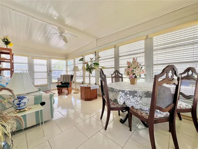 a dining room with wooden floor and chandelier