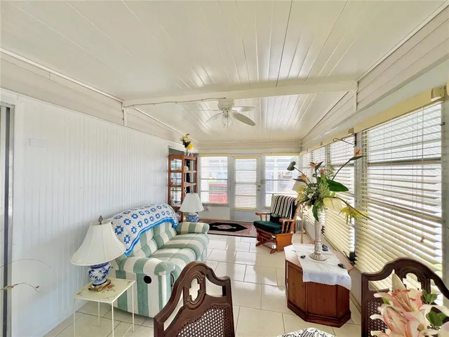a view of a dining room with furniture a chandelier and wooden floor