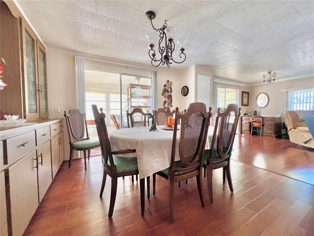 1100 South Belcher Road, Unit 719 Largo, FL 33771 - Photo 22 of 60 a view of a dining room with furniture window and wooden floor