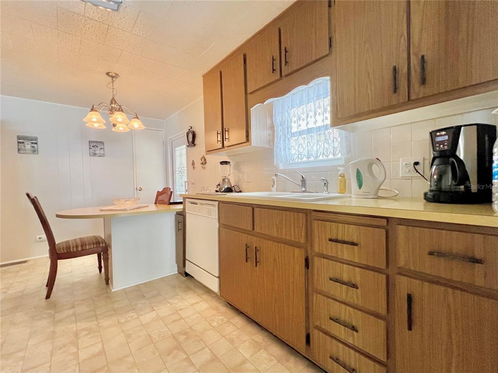 1100 South Belcher Road, Unit 719 Largo, FL 33771 - Photo 27 of 60 a kitchen with cabinets a sink and appliances