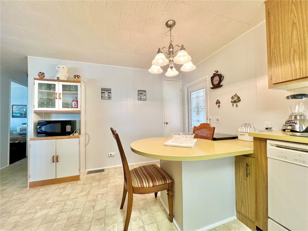 1100 South Belcher Road, Unit 719 Largo, FL 33771 - Photo 32 of 60 a view of a dining room with furniture and chandelier