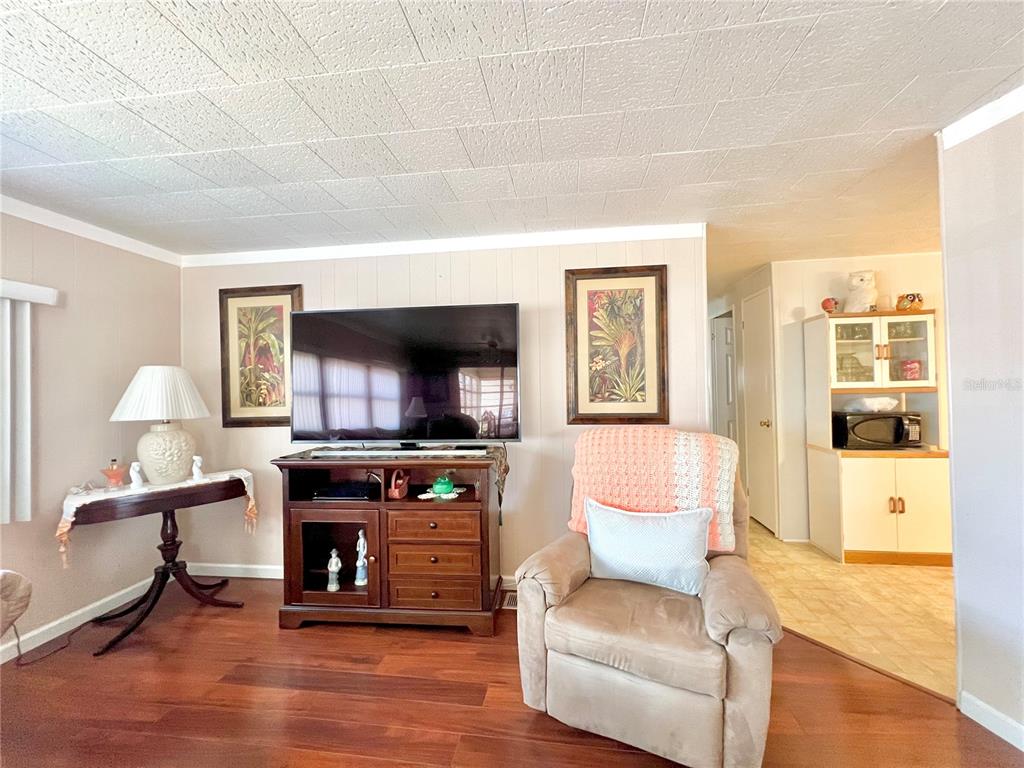 1100 South Belcher Road, Unit 719 Largo, FL 33771 - Photo 37 of 60 a living room with furniture and a flat screen tv