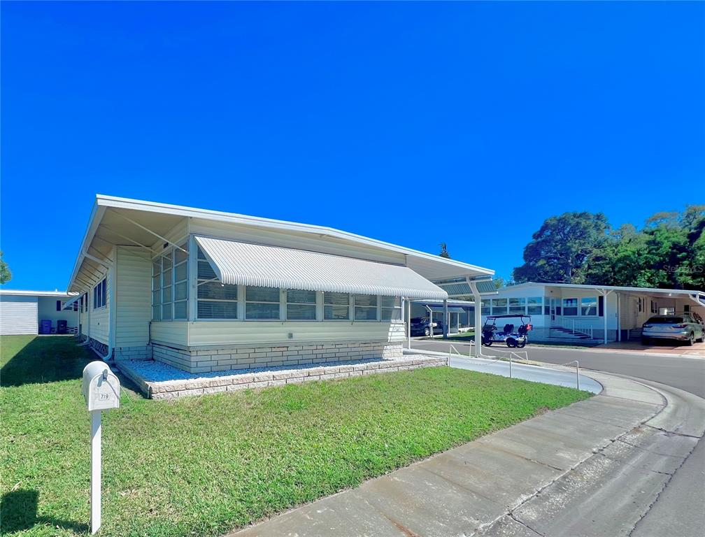 1100 South Belcher Road, Unit 719 Largo, FL 33771 - Photo 4 of 60 a view of house with swimming pool yard and outdoor seating