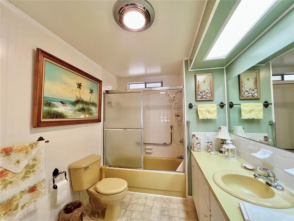 1100 South Belcher Road, Unit 719 Largo, FL 33771 - Photo 41 of 60 a bathroom with a sink a mirror a toilet and bathtub