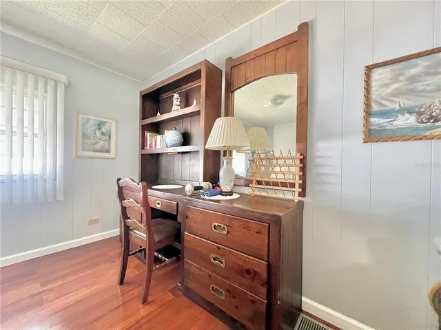 a bedroom with furniture and a chair