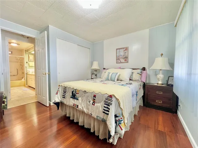 a spacious bedroom with a bed and a chandelier