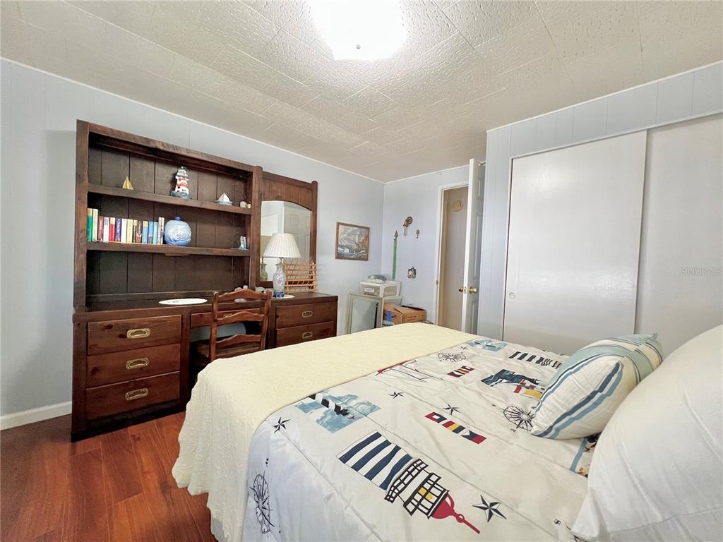 1100 South Belcher Road, Unit 719 Largo, FL 33771 - Photo 47 of 60 a bedroom with a bed and a cabinets