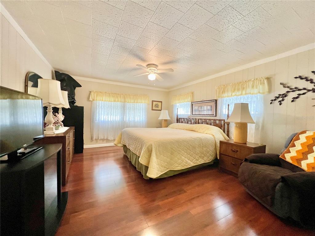 1100 South Belcher Road, Unit 719 Largo, FL 33771 - Photo 53 of 60 a bedroom with a bed and wooden floor