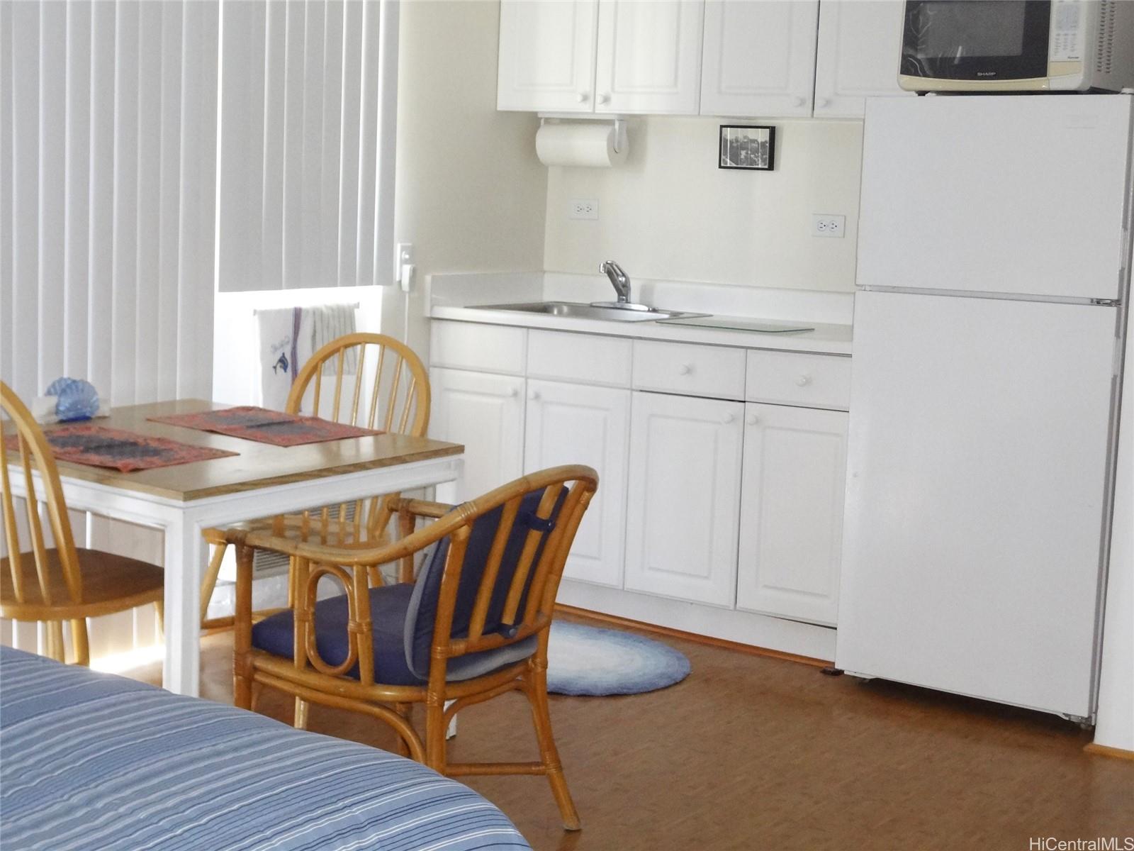 2572 Lemon Road, Unit 803 Honolulu, HI 96815 - Photo 2 of 6 a dining room with furniture and wooden floor