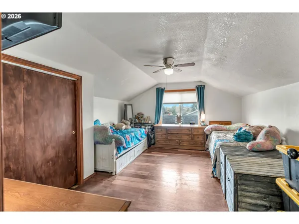 a bed room with a bed and a view of kitchen
