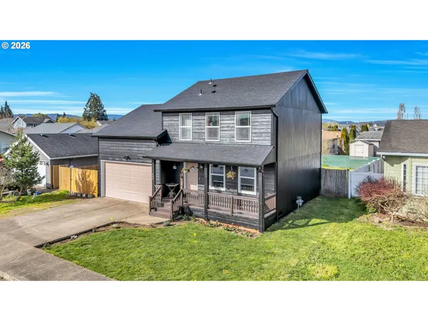 a view of a house with a backyard porch and sitting area