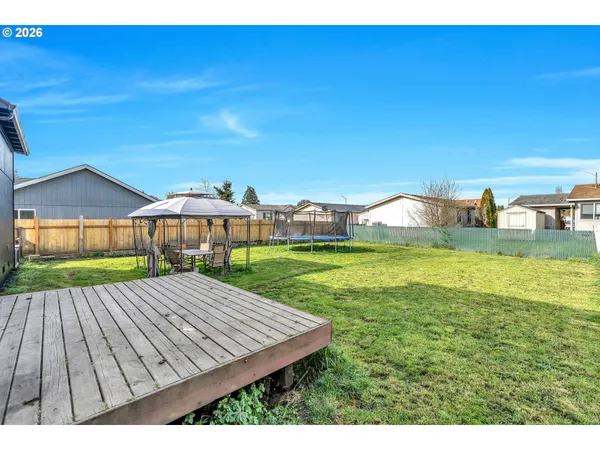 a backyard of a house with table and chairs