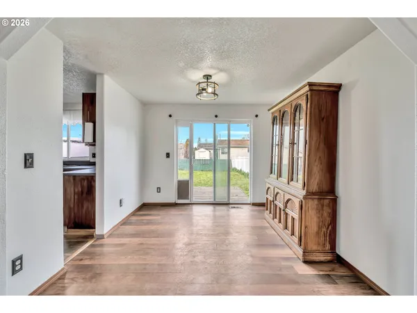 a view of an entryway with wooden floor