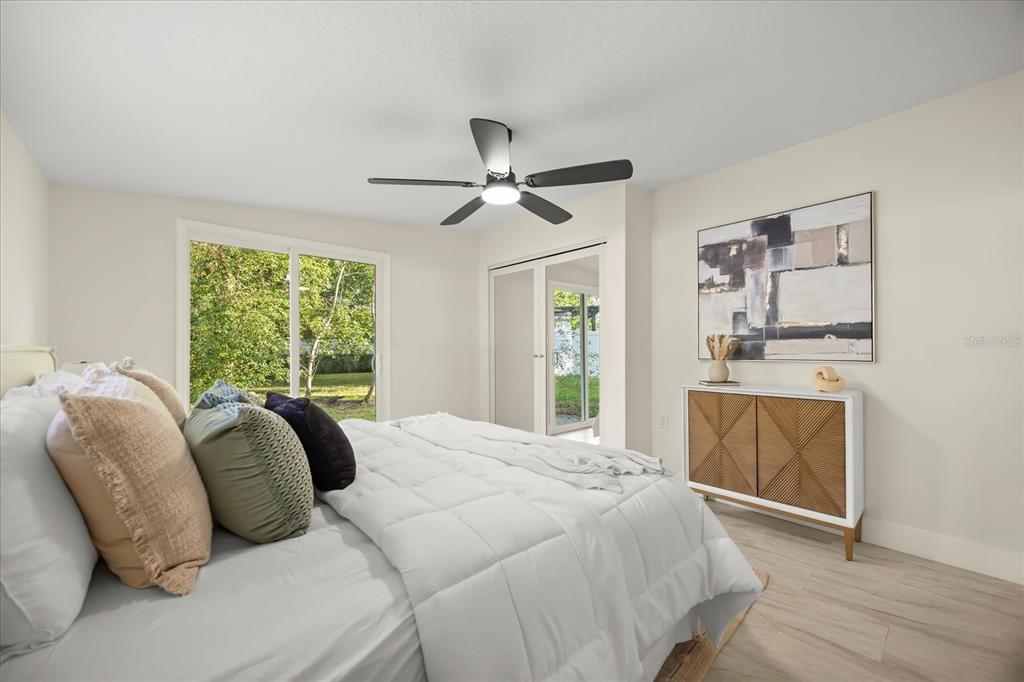 115 West Fillmore Avenue Orlando, FL 32809 - Photo 11 of 23 a bedroom with a bed and a chandelier