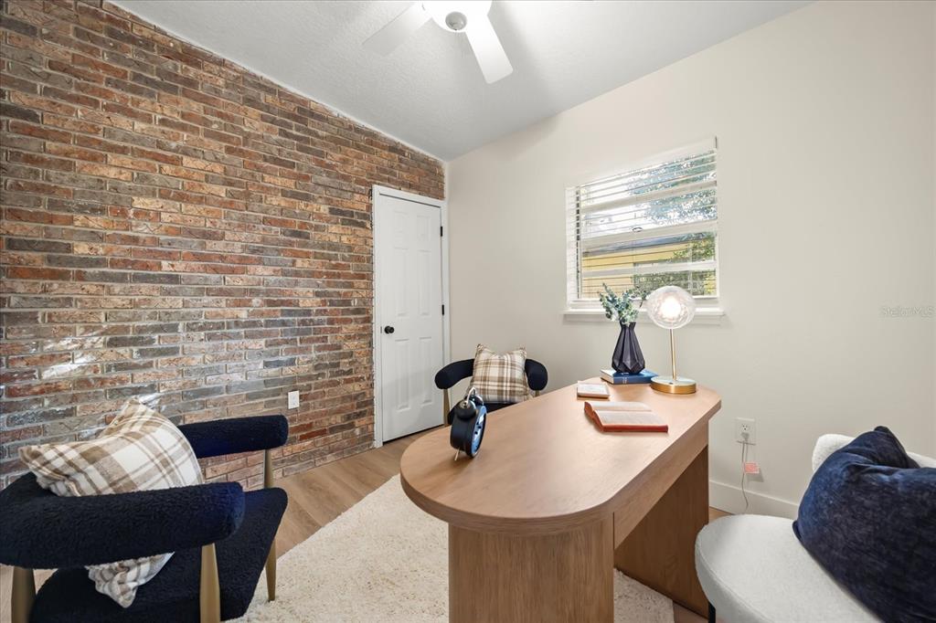 115 West Fillmore Avenue Orlando, FL 32809 - Photo 13 of 23 a dining room with furniture and a fireplace