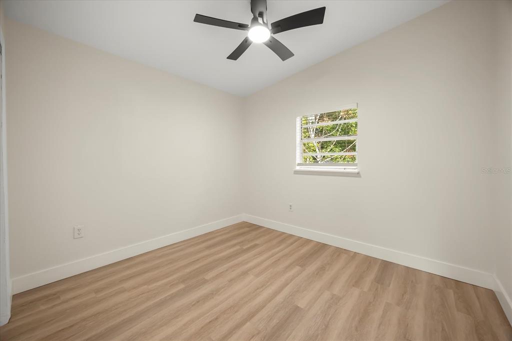 115 West Fillmore Avenue Orlando, FL 32809 - Photo 17 of 23 an empty room with a window and a ceiling fan