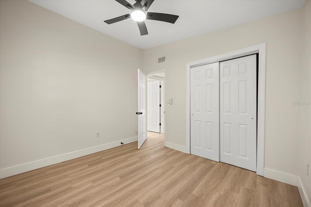 115 West Fillmore Avenue Orlando, FL 32809 - Photo 18 of 23 an empty room with wooden floor and windows