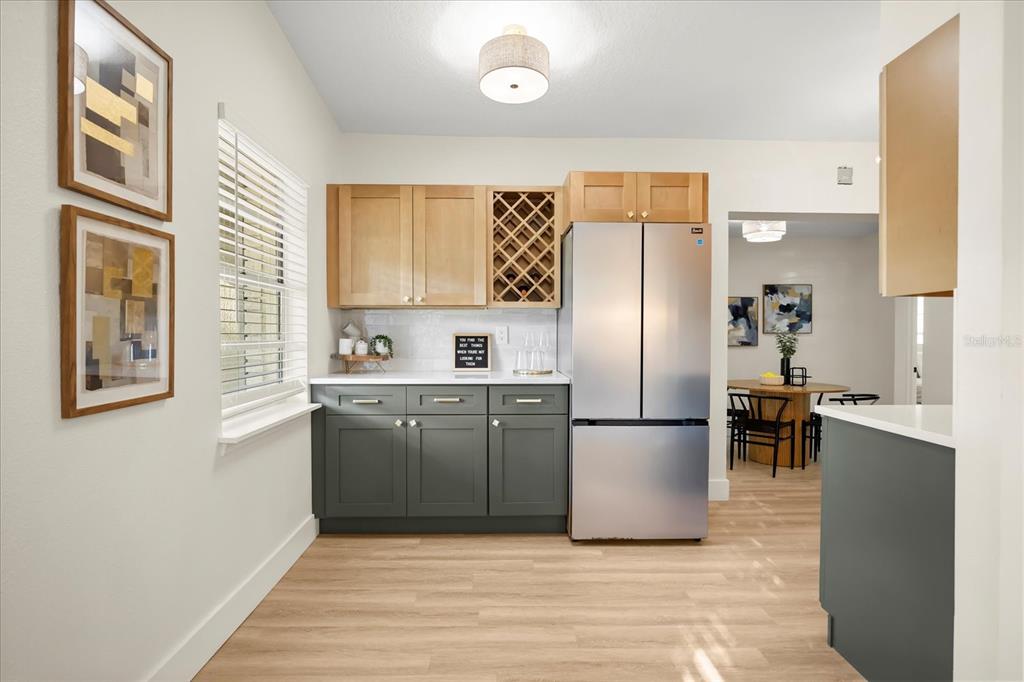 115 West Fillmore Avenue Orlando, FL 32809 - Photo 5 of 23 a kitchen with a refrigerator and a sink