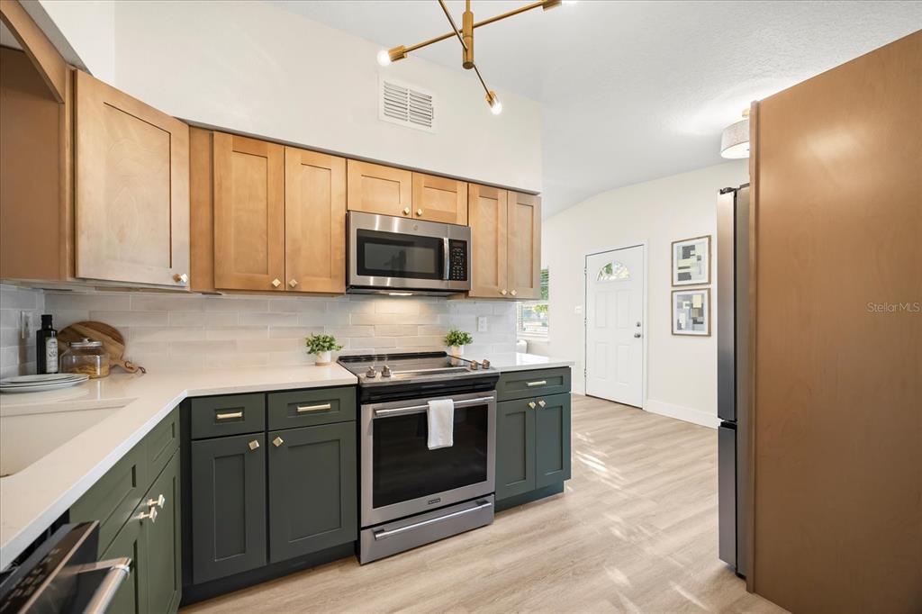 115 West Fillmore Avenue Orlando, FL 32809 - Photo 6 of 23 a kitchen with stainless steel appliances granite countertop a stove top oven a sink and dishwasher