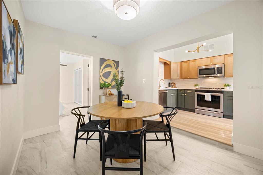 115 West Fillmore Avenue Orlando, FL 32809 - Photo 7 of 23 a view of a dining room with furniture and wooden floor