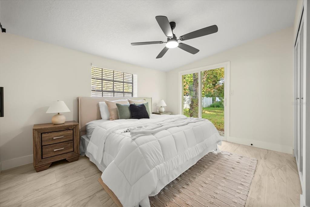 115 West Fillmore Avenue Orlando, FL 32809 - Photo 10 of 23 a bedroom with a large bed and a window