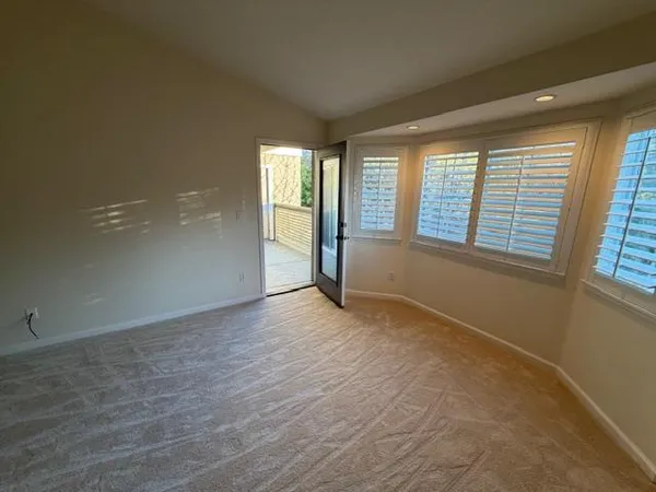 a view of a room that has a bed in it