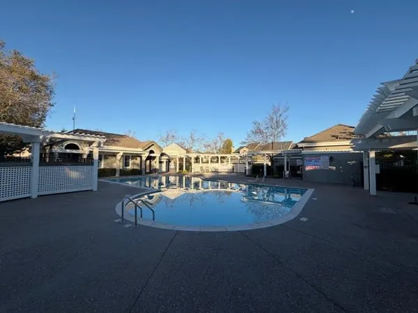 a view of a swimming pool with lawn chairs