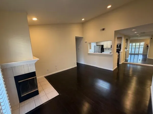 a view of a kitchen with wooden floor and a ceiling fan