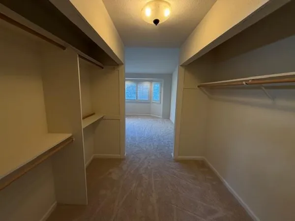an empty room with windows and closet