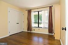 12908 Gent Road Reisterstown, MD 21136 - Photo 18 of 29 a view of an empty room with a window and wooden floor