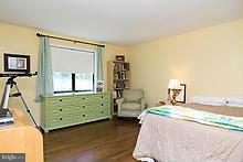 12908 Gent Road Reisterstown, MD 21136 - Photo 22 of 29 a bedroom with a bed and a mirror on the dresser