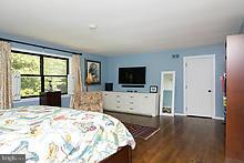 12908 Gent Road Reisterstown, MD 21136 - Photo 25 of 29 a bed room with furniture and a flat screen tv