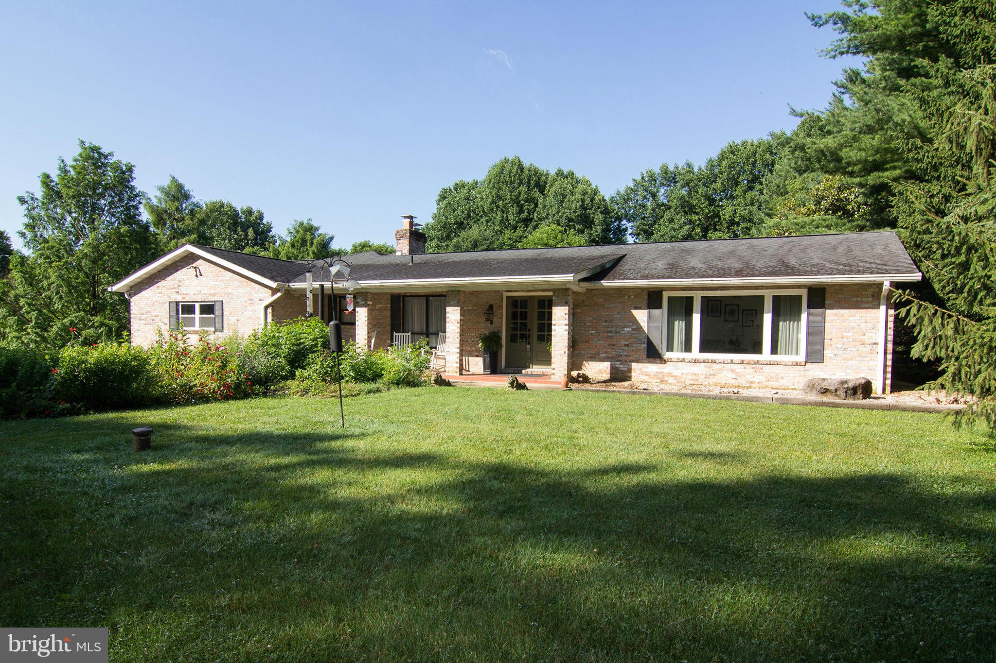 12908 Gent Road Reisterstown, MD 21136 - Photo 4 of 29 a front view of a house with a yard table and trees