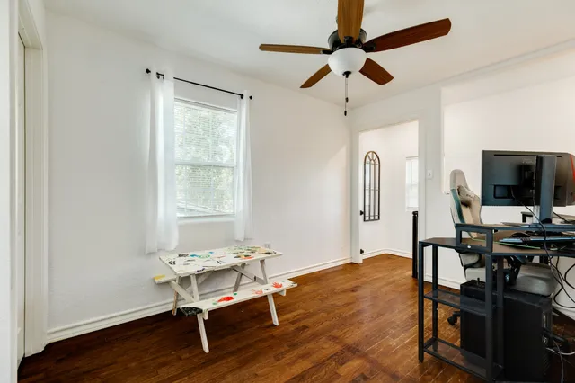 a living room with furniture a flat screen tv and a window