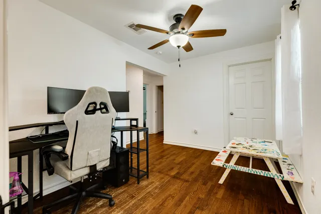 a view of a workspace with wooden floor
