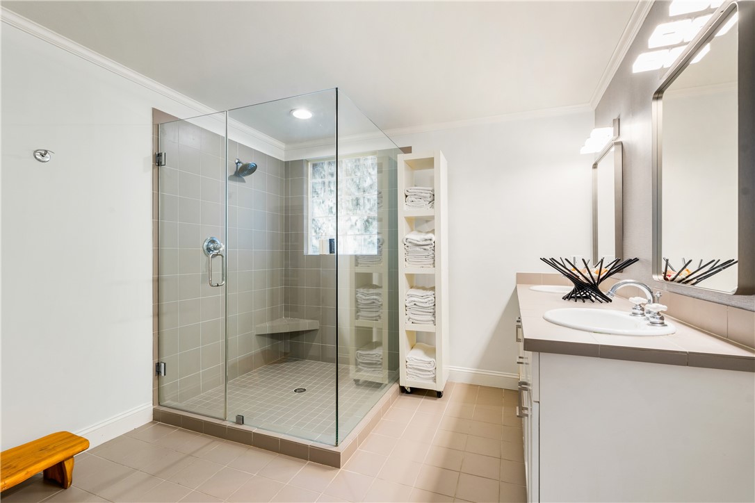 975 Riomar Drive Vero Beach, FL 32963 - Photo 28 of 34 a bathroom with a shower sink and mirror