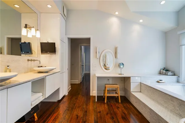 a large kitchen with a sink and breakfast area