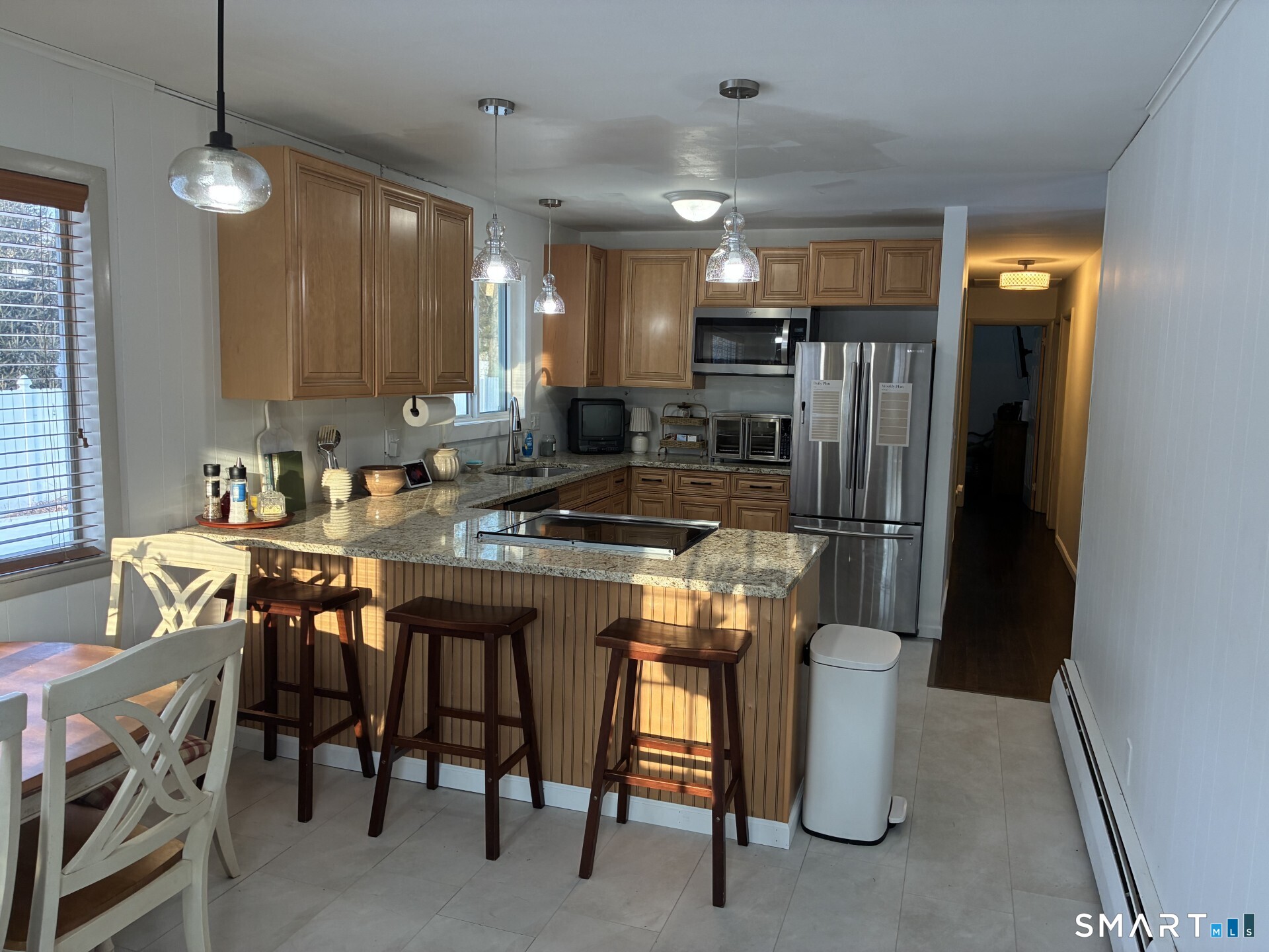 4 Shady Rest Boulevard Newtown, CT 06482 - Photo 5 of 34 a kitchen with refrigerator and chairs
