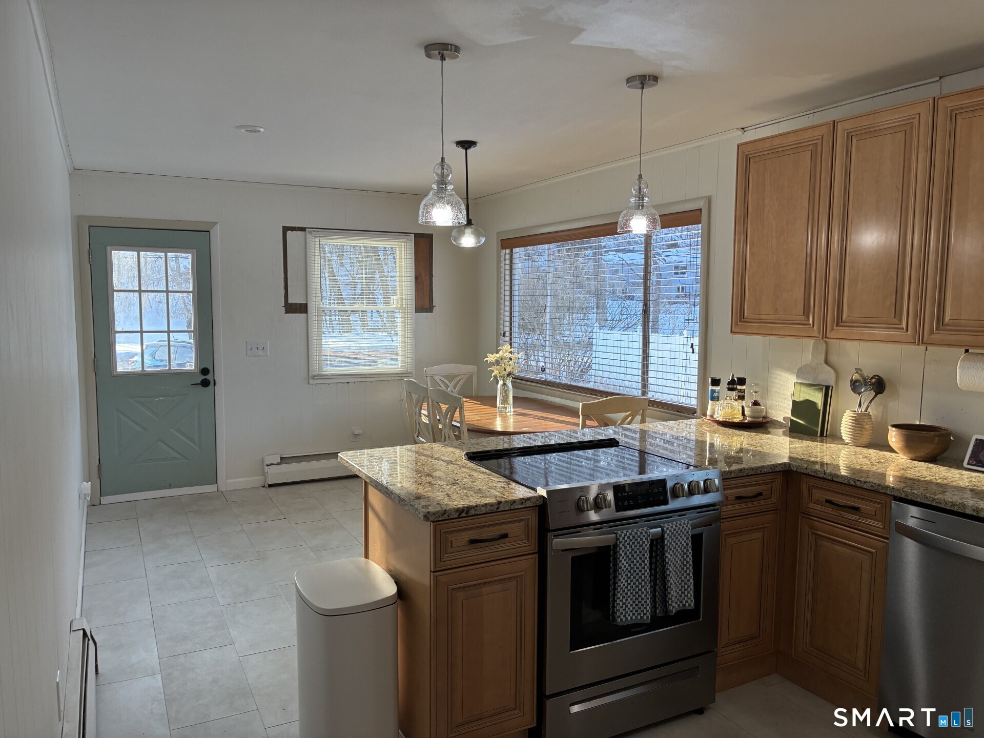4 Shady Rest Boulevard Newtown, CT 06482 - Photo 6 of 34 a kitchen with stainless steel appliances granite countertop a stove a sink dishwasher a refrigerator and white cabinets with wooden floor