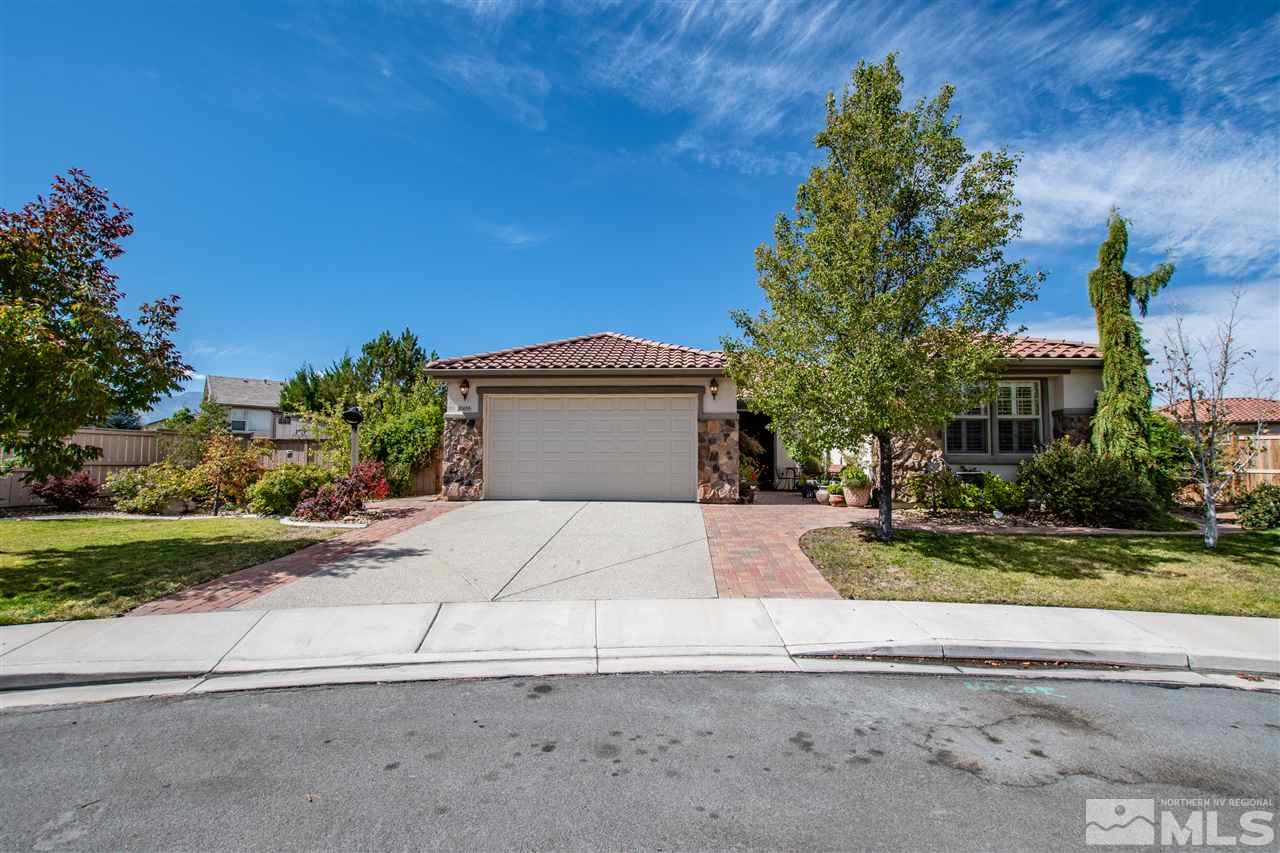 10655 Cedar Bend Court Reno, NV 89521 - Photo 1 of 16 a front view of a house with a yard and a garage