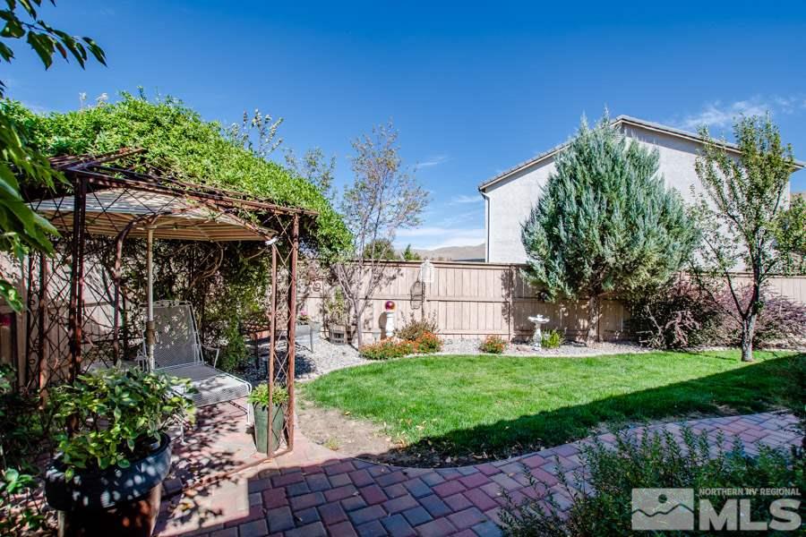 10655 Cedar Bend Court Reno, NV 89521 - Photo 11 of 16 a view of a house with a yard and potted plants
