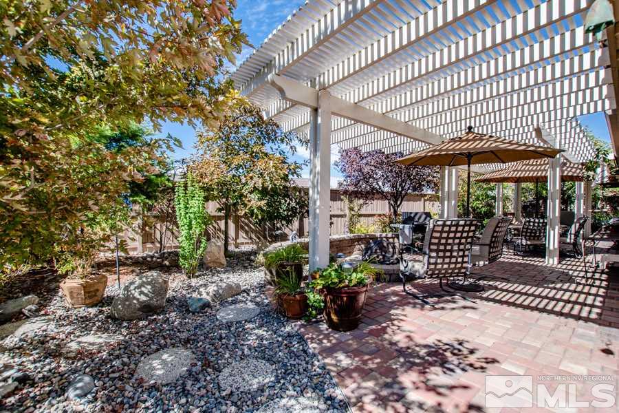 10655 Cedar Bend Court Reno, NV 89521 - Photo 14 of 16 a view of a patio with table and chairs potted plants