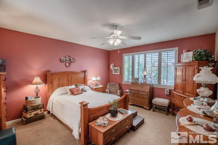 10655 Cedar Bend Court Reno, NV 89521 - Photo 7 of 16 a bedroom with a bed and a couch