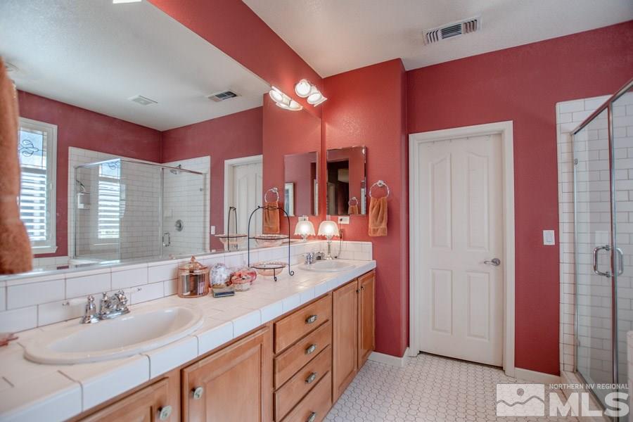 10655 Cedar Bend Court Reno, NV 89521 - Photo 9 of 16 a spacious bathroom with a double vanity sink and a mirror