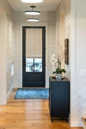 a living room with a large window and wooden floor