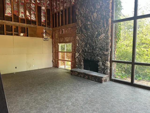 a view of a room with wooden floor and cabinets