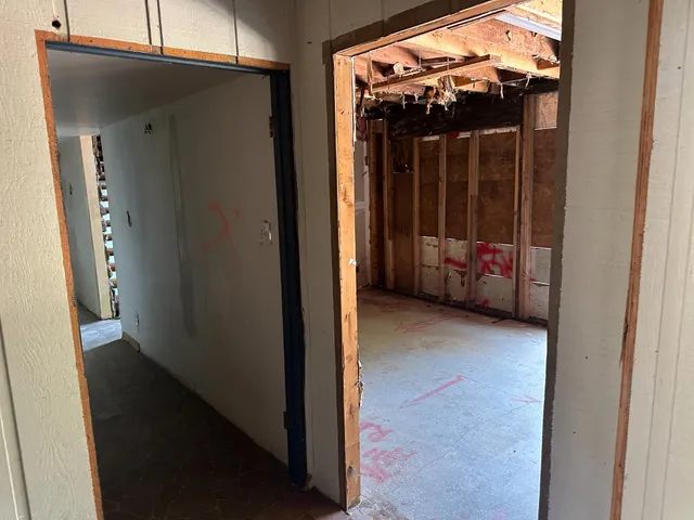 a view of a room with a bed and a window