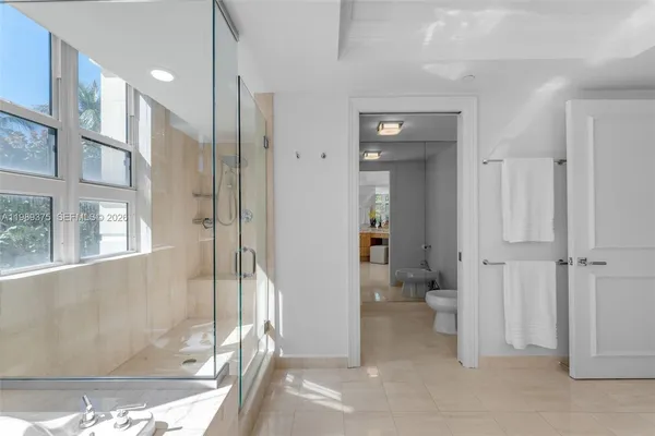 a bathroom with a glass shower door and a toilet