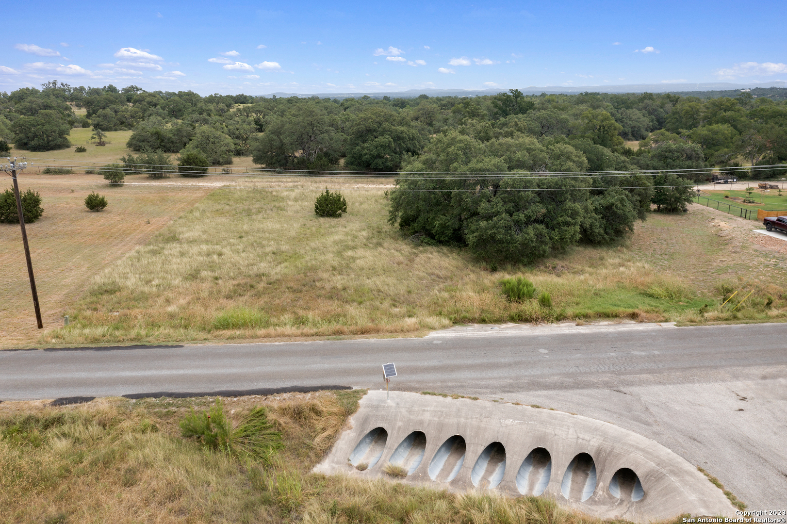 a view of a yard with wooden fence
